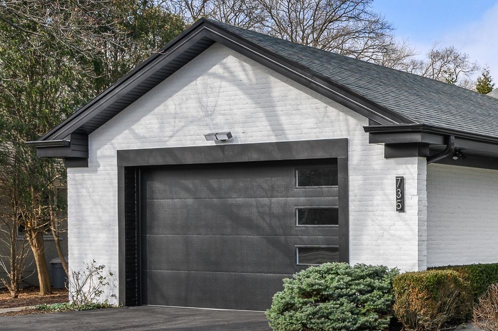 New black glass garage door installed on a Winnetka IL home by Preferred Garage Door Repair Company