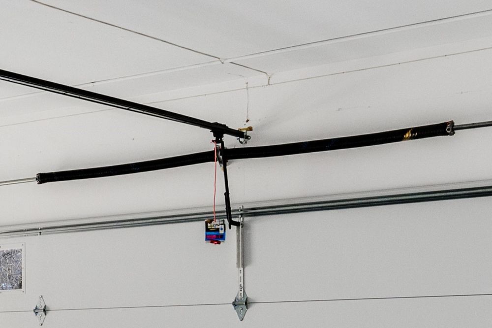 Torsion spring replacement on a residential garage door in Chicago suburbs
